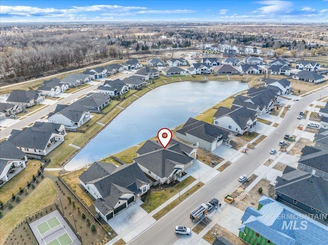 birds eye view of property featuring a water view and a residential view