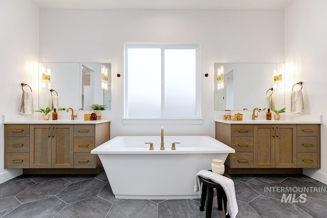 bathroom featuring tile patterned floors, vanity, and a bath