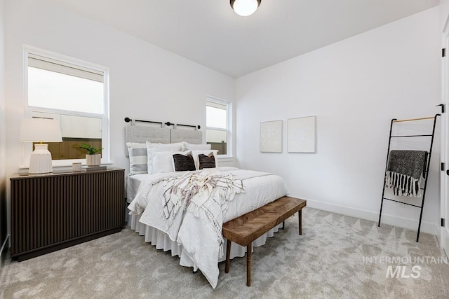 bedroom featuring radiator heating unit and light colored carpet