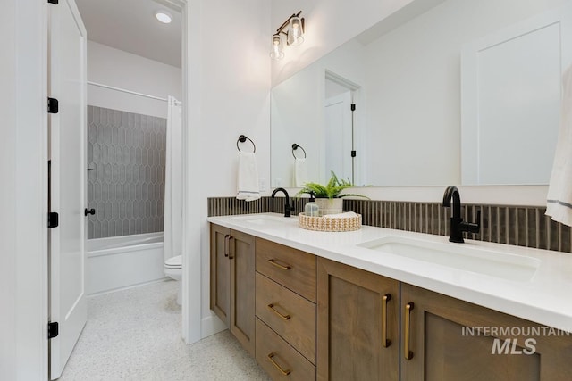 full bathroom featuring shower / bath combo with shower curtain, vanity, and toilet