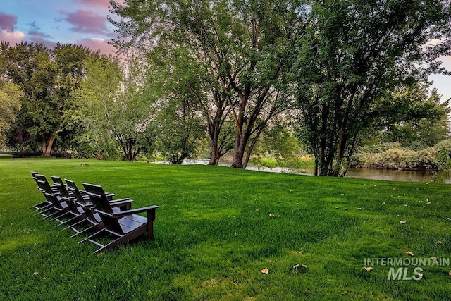 yard at dusk with a water view
