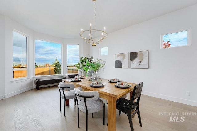 dining room featuring light hardwood / wood-style floors and an inviting chandelier
