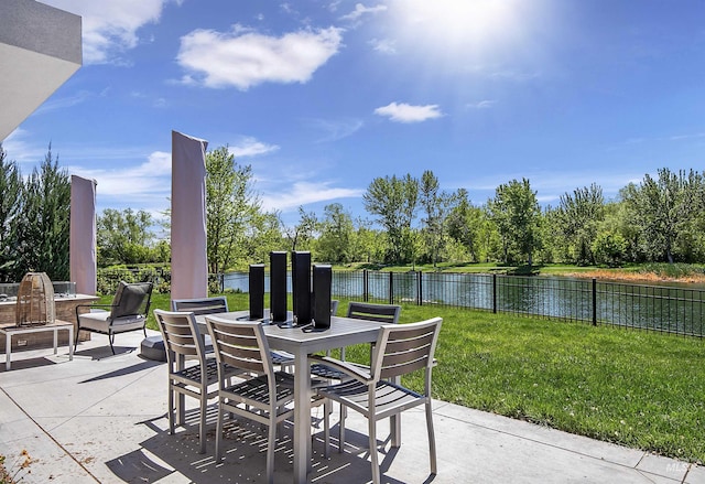 view of patio with outdoor dining area and a water view