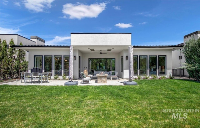 rear view of house with an outdoor living space with a fire pit, stucco siding, a patio, a ceiling fan, and a chimney