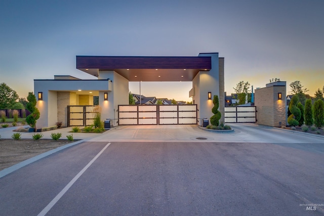 view of front of house with a gate and stucco siding