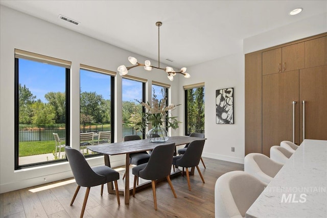 dining room featuring plenty of natural light, a chandelier, wood finished floors, and recessed lighting