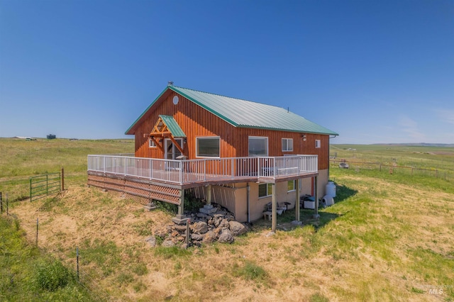 view of front facade with a rural view and a deck