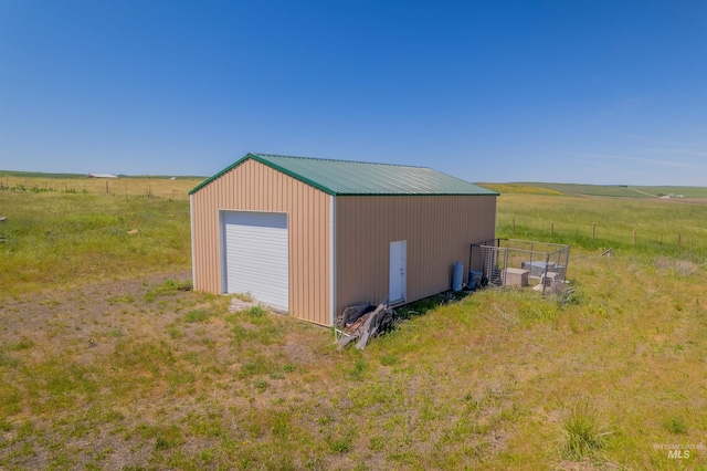 view of outdoor structure with a rural view and a garage