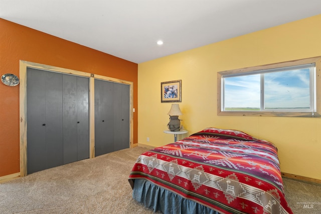 bedroom with two closets and carpet