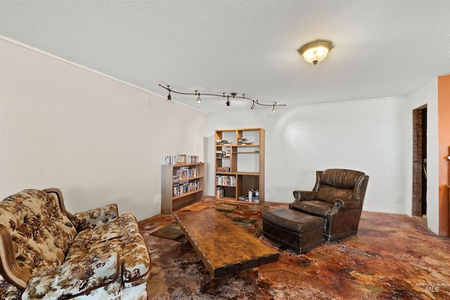 living room with a textured ceiling and track lighting