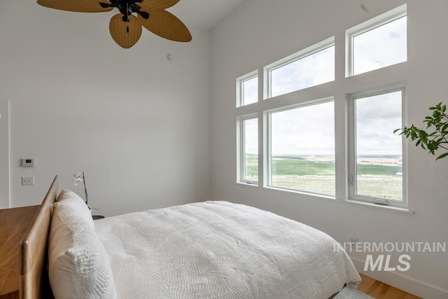 bedroom with wood finished floors and a ceiling fan