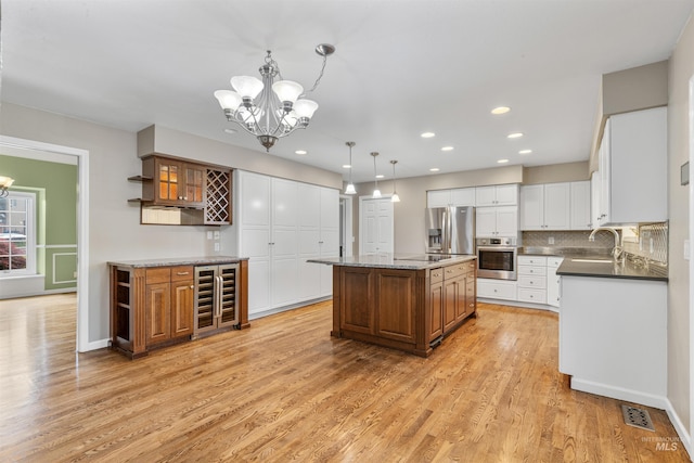 2220 14th St, Lewiston, ID 83501 - kitchen featuring stainless steel appliances, wine cooler, a chandelier, light wood-style flooring, and recessed lighting