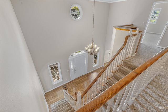 2220 14th St, Lewiston, ID 83501 - staircase with a chandelier, a towering ceiling, and baseboards
