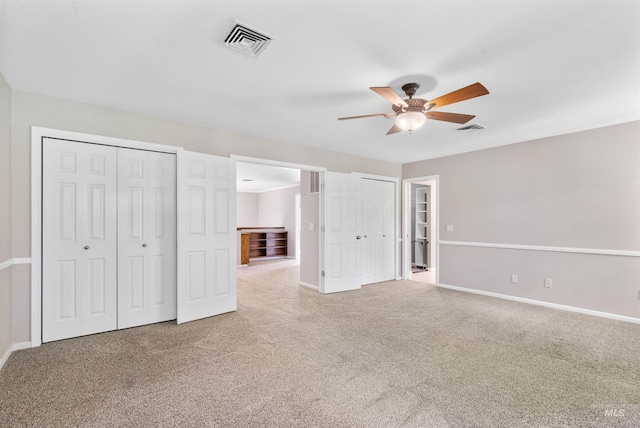 2220 14th St, Lewiston, ID 83501 - unfurnished bedroom with carpet flooring, baseboards, two closets, and a ceiling fan