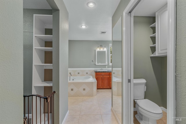 2220 14th St, Lewiston, ID 83501 - full bathroom with toilet, a garden tub, tile patterned flooring, and vanity