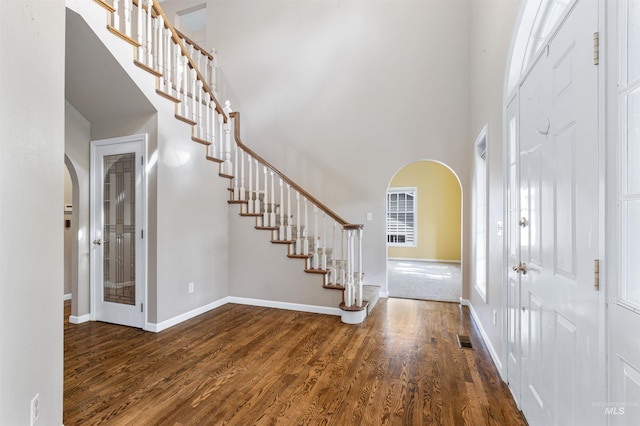 2220 14th St, Lewiston, ID 83501 - foyer entrance with arched walkways, stairway, wood finished floors, a high ceiling, and baseboards