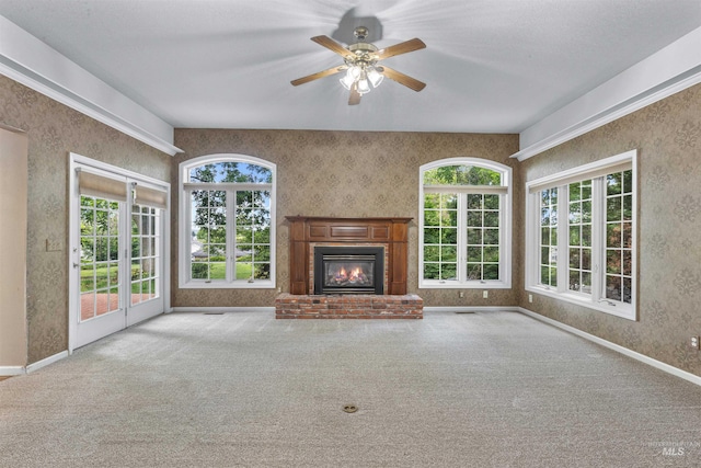 2220 14th St, Lewiston, ID 83501 - unfurnished living room with wallpapered walls, carpet floors, a fireplace, and plenty of natural light