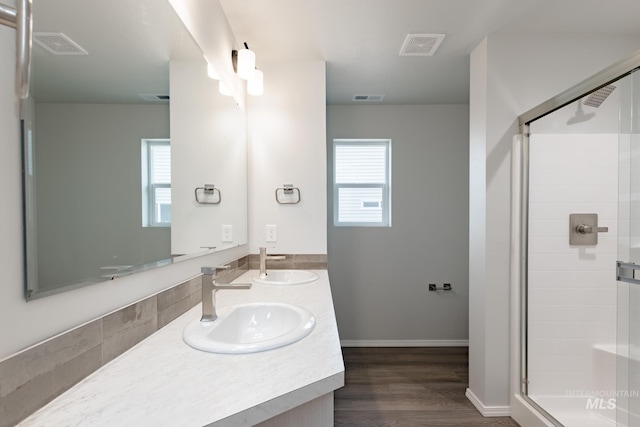 7343 E Marble Springs Dr, Nampa, ID 83687 - bathroom with a shower stall, healthy amount of natural light, wood finished floors, and double vanity
