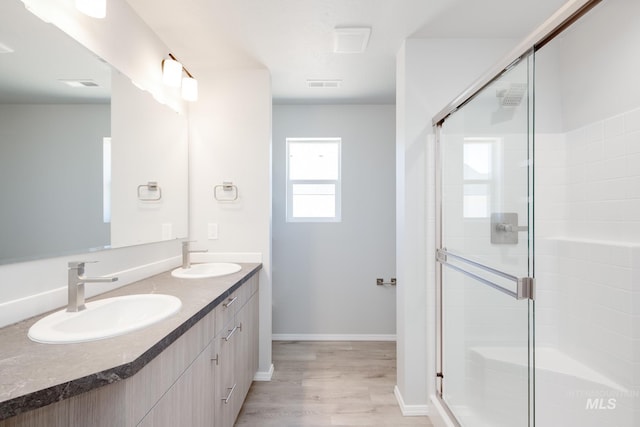 7343 E Marble Springs Dr, Nampa, ID 83687 - full bathroom with a stall shower, wood finished floors, double vanity, and baseboards