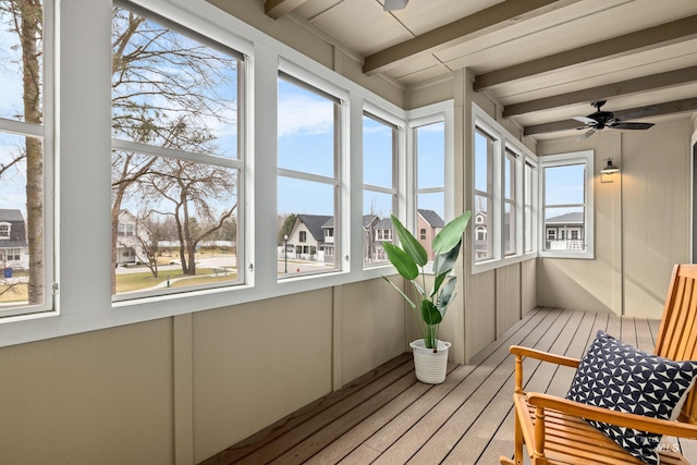 sunroom featuring ceiling fan and beamed ceiling