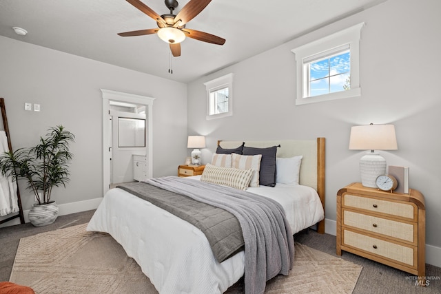 carpeted bedroom featuring ceiling fan, baseboards, and ensuite bathroom