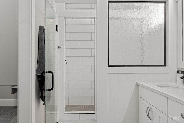 bathroom featuring a shower stall and vanity