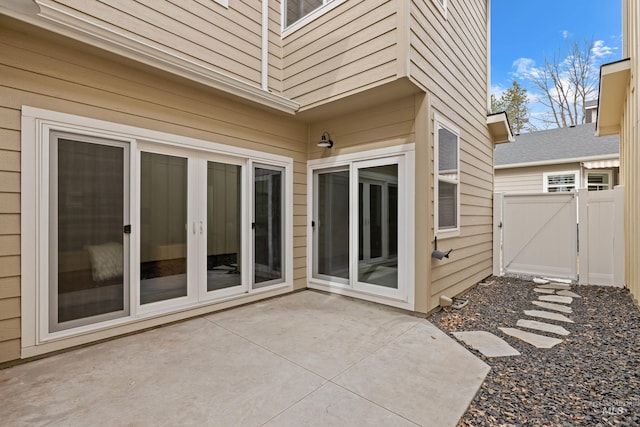 view of patio with a gate and fence