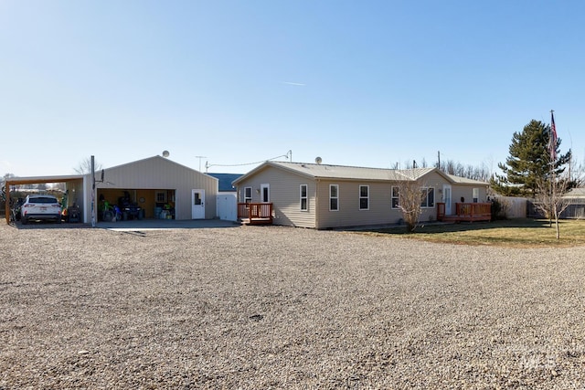 view of front of house with a carport and a deck