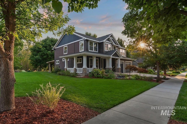 craftsman inspired home featuring a porch and a yard