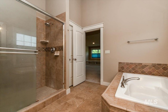 bathroom featuring plus walk in shower and tile patterned flooring