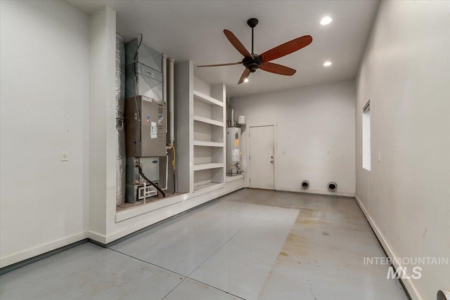 interior space featuring heating unit, concrete flooring, water heater, and ceiling fan