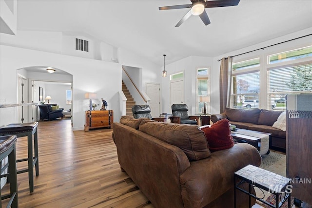 2904 E Umatilla Dr, Nampa, ID 83686 - living area featuring a ceiling fan, arched walkways, vaulted ceiling, stairs, and light wood-style flooring