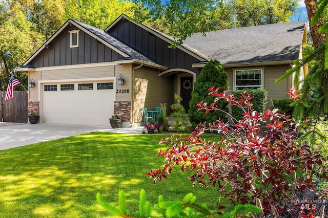20268 Lolo Ave, Caldwell, ID 83605 - view of front facade with board and batten siding, an attached garage, concrete driveway, and a shingled roof