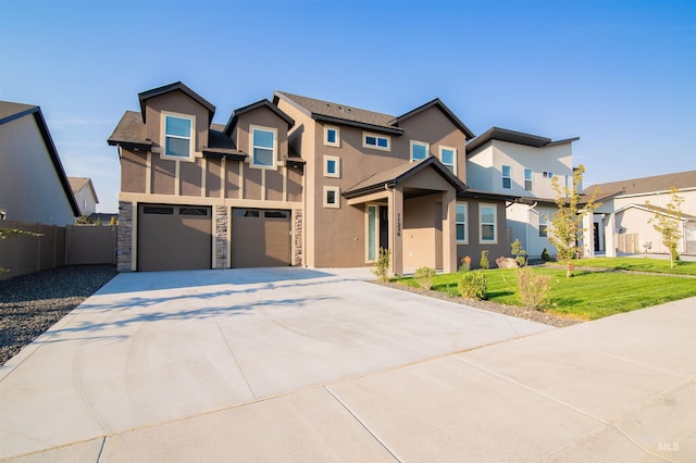 view of front of home featuring a garage and a front yard