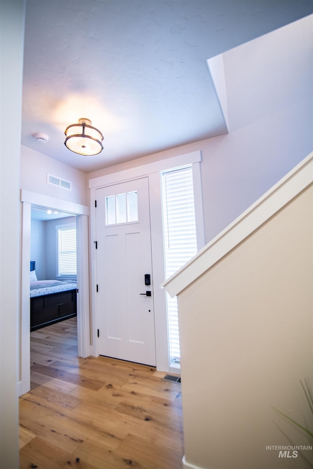 entryway with light hardwood / wood-style floors