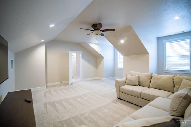 living room with lofted ceiling, light colored carpet, and ceiling fan