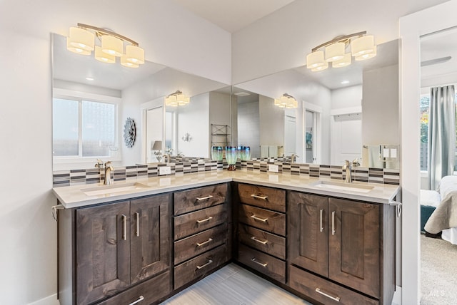 bathroom with vanity and tasteful backsplash