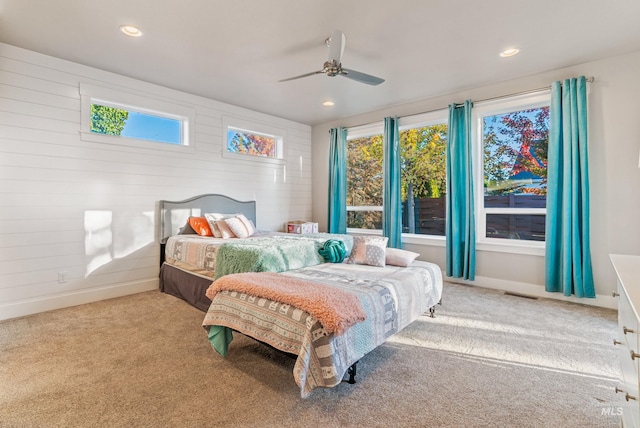 bedroom featuring light colored carpet and ceiling fan