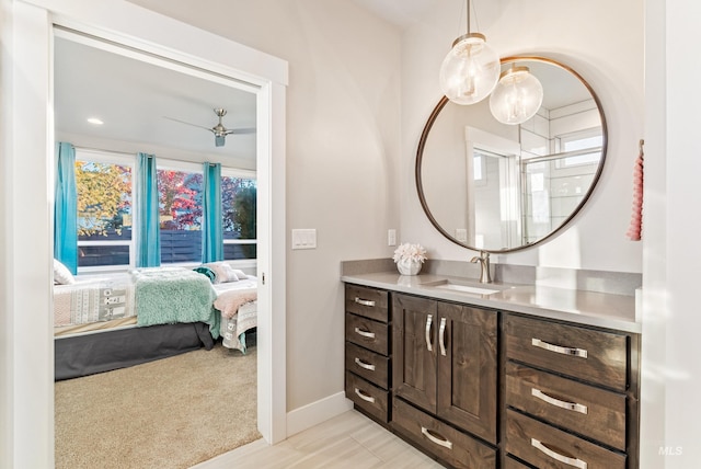 bathroom featuring vanity, ceiling fan, and a shower with shower door