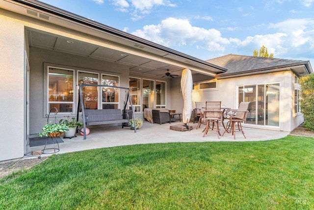 back of house featuring a patio, outdoor lounge area, a yard, and ceiling fan