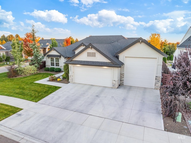 view of front of property with a front yard and a garage