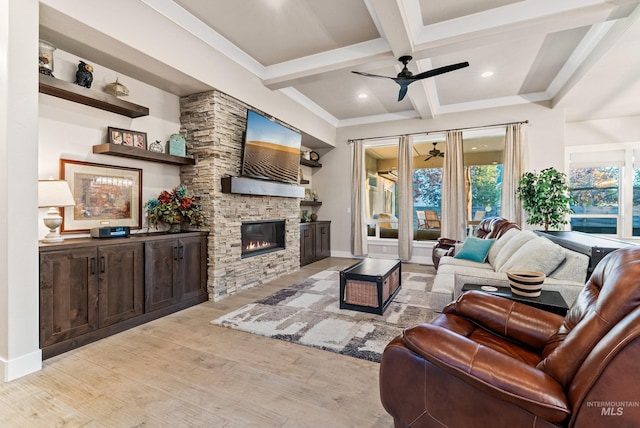 living room featuring coffered ceiling, beam ceiling, light hardwood / wood-style flooring, a fireplace, and ceiling fan