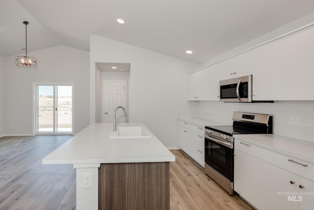 kitchen featuring sink, hanging light fixtures, an island with sink, white cabinets, and appliances with stainless steel finishes