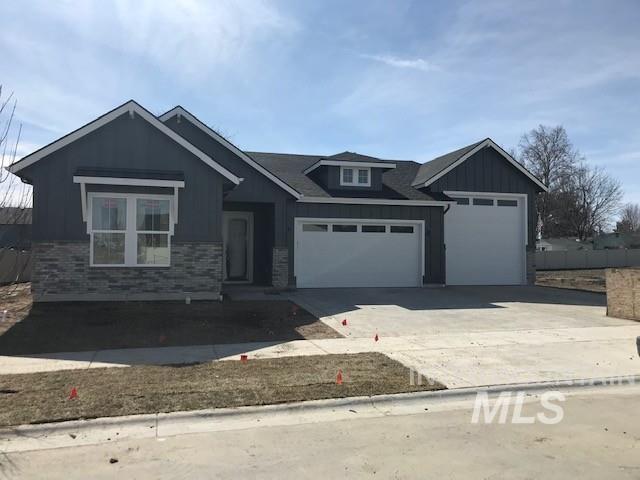 craftsman-style home featuring board and batten siding, concrete driveway, and a garage