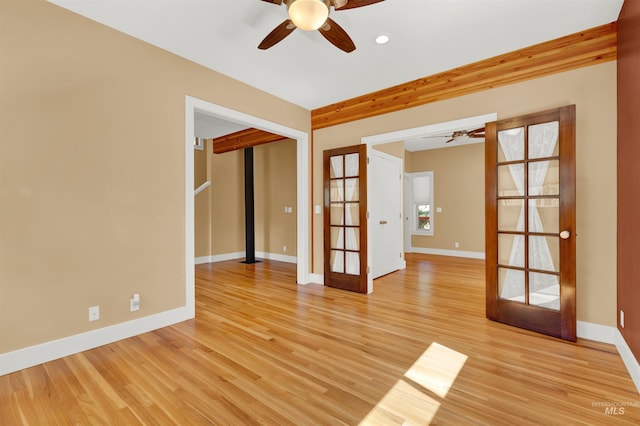 empty room featuring ceiling fan, light hardwood / wood-style flooring, and french doors