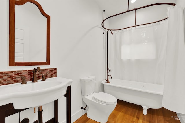 bathroom with wood-type flooring, tasteful backsplash, toilet, and shower / bath combo with shower curtain