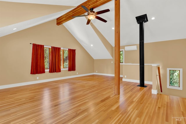 additional living space featuring beam ceiling, ceiling fan, high vaulted ceiling, an AC wall unit, and light wood-type flooring
