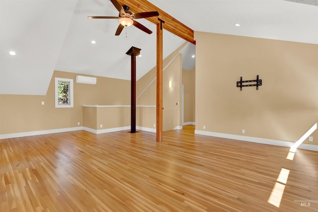 unfurnished living room featuring ceiling fan, beam ceiling, high vaulted ceiling, an AC wall unit, and light hardwood / wood-style floors