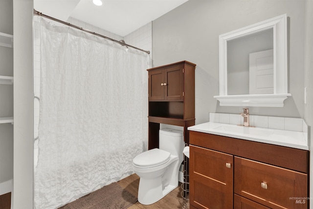bathroom featuring a shower with shower curtain, vanity, wood-type flooring, and toilet