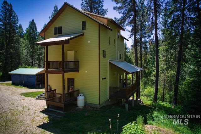 rear view of property featuring a balcony